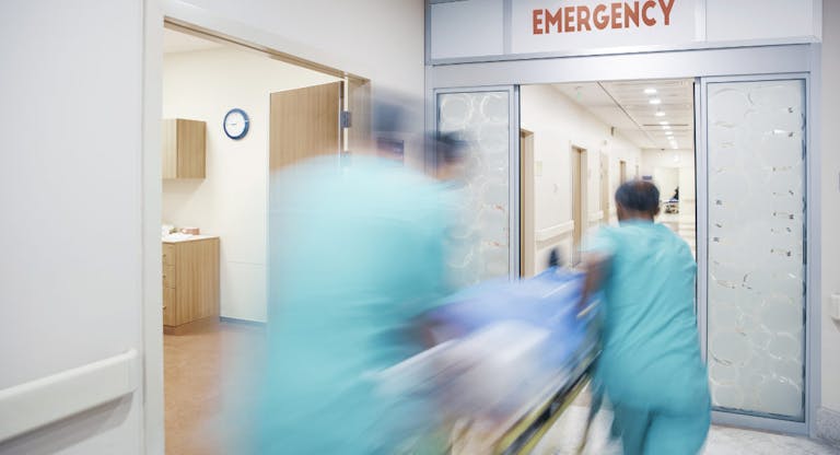 Doctor wheeling patient