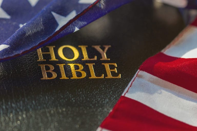 American flag draped over bible