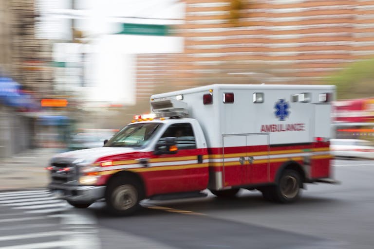 Photo: B&M Noskowski/MACIEJ NOSKOWSKI (Getty Images) Blurred image of an ambulance on a city street