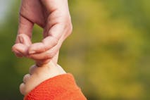 Child holding mothers hand