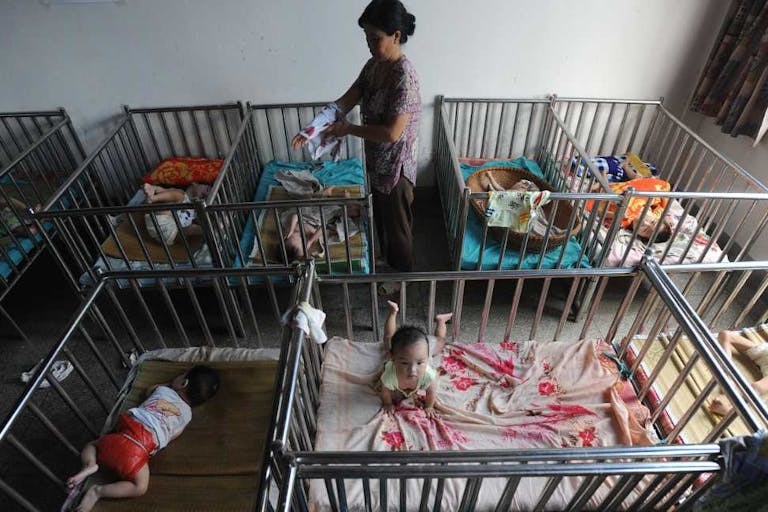 A Chinese worker cares for the babies at