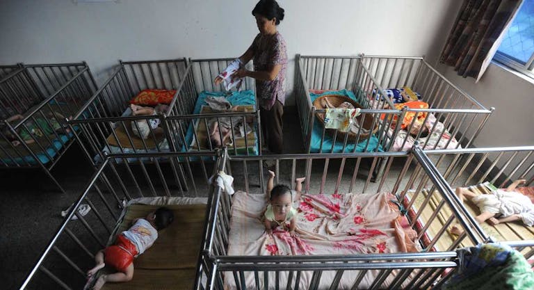 A Chinese worker cares for the babies at