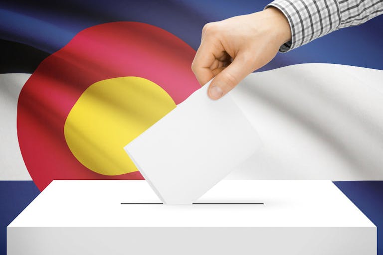 Ballot box with national flag on background – Colorado