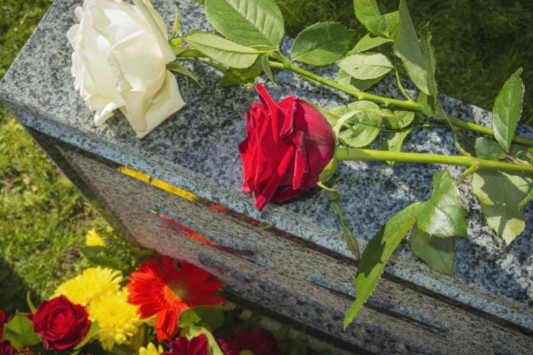 White And Red Rose On Tombstone