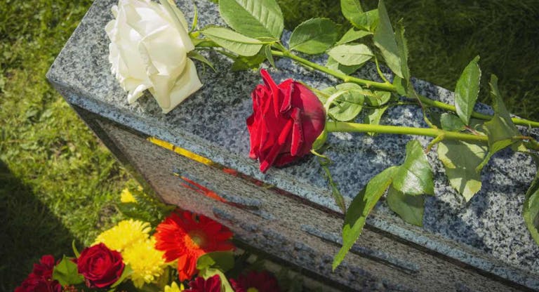 White And Red Rose On Tombstone