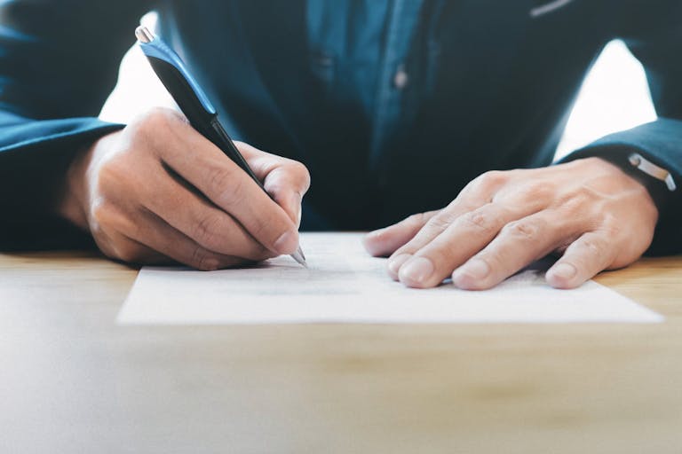 Businessman signing contract making a deal.