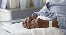 Black woman recovering in hospital bed