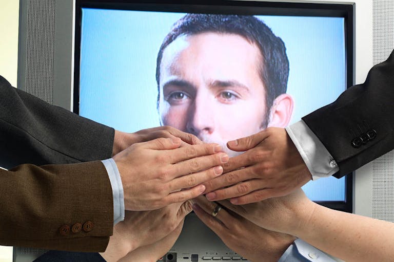 Hands covering mouth of man displayed on tv