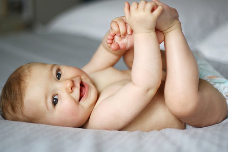 7 month old baby on bed