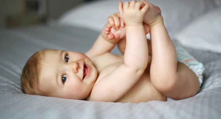 7 month old baby on bed