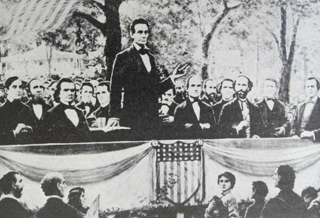 Abraham Lincoln (standing) in one of a series of seven debates regarding slavery with Stephen Douglas (at Lincoln’s right), his rival for a seat in the Senate. These debates permitted both candidates to discuss their views on slavery. (Photo by: Universal History Archive/UIG via Getty images)