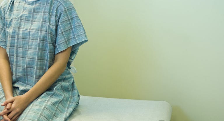 Patient waiting on examination table