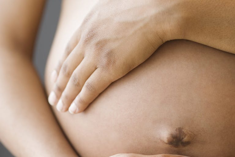 Close up of pregnant African American woman’s belly