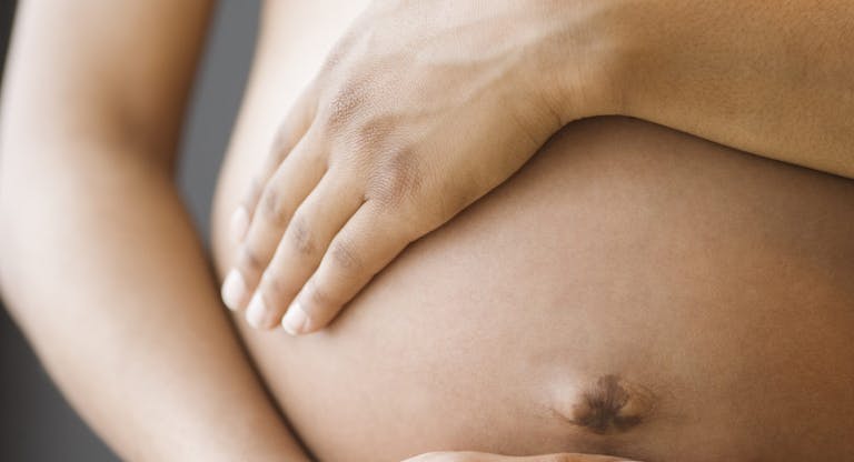 Close up of pregnant African American woman’s belly