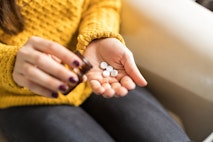 Woman Taking Out Pills From Bottle