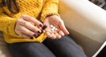 Woman Taking Out Pills From Bottle
