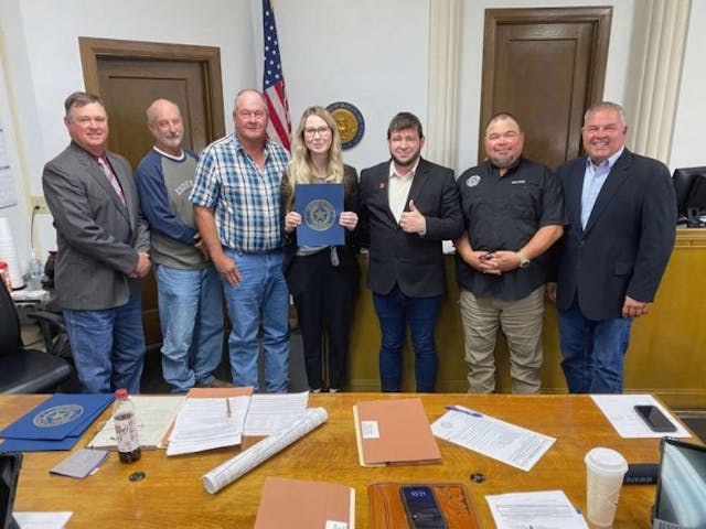 Jack County resident Tayte Ward and Right to Life of East Texas Director Mark Lee Dickson take a picture with the Jack County Commissioners and Jack County Judge after the passage of the Sanctuary County for the Unborn Ordinance. (Photo: Mark Lee Dickson)