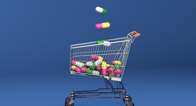 Shoping cart filled with antibiotics capsule pills. Top view. On blue background. 3D Illustration