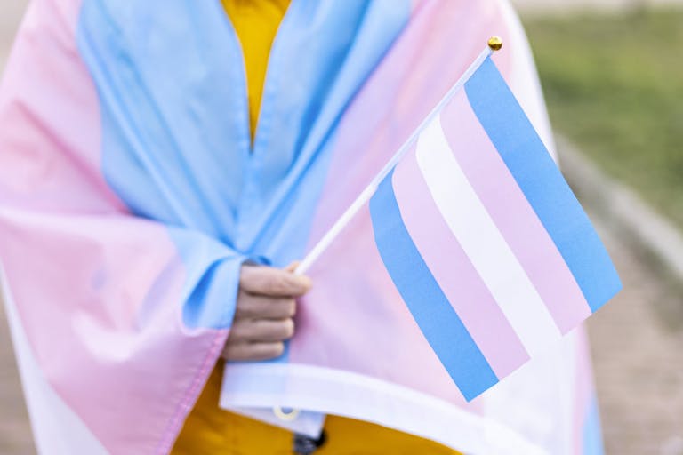 Photo: Getty Images Woman covered with the transgender flag on a protest