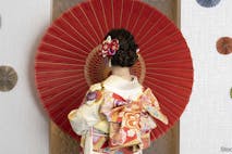 Female adult in kimono with an umbrella spread