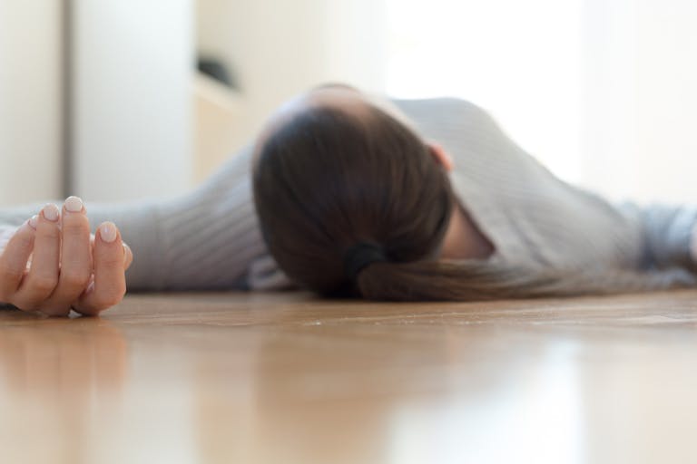 Woman lying on the floor at home