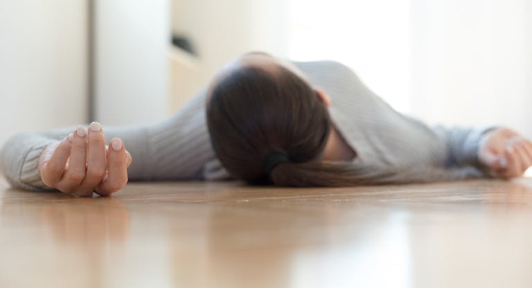 Woman lying on the floor at home