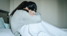 Image of woman crying with her head down. loss, abortion, Japan, miscarriage