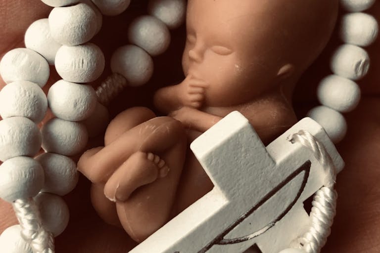 Fetus with rosary
