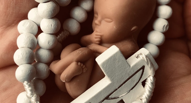 Fetus with rosary