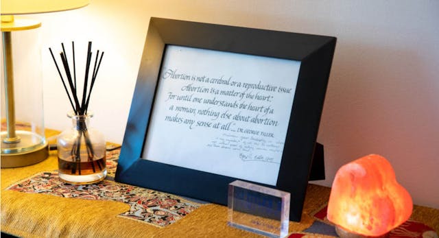 WASHINGTON, D.C. – JULY 1: A framed and signed note from legendary abortion provider and advocate Dr. George Tiller in the office of Melissa Grant at the headquarters of Carafem in Washington, D.C., on July 1, 2022. (Amanda Andrade-Rhoades/For The Washington Post via Getty Images)