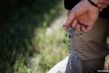 prayer, spain, violence against man praying rosary at Planned Parenthood
