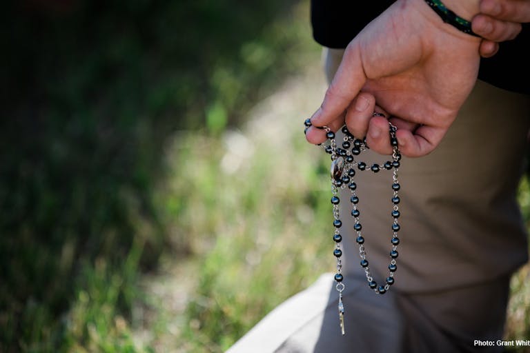 prayer, spain, violence against man praying rosary at Planned Parenthood