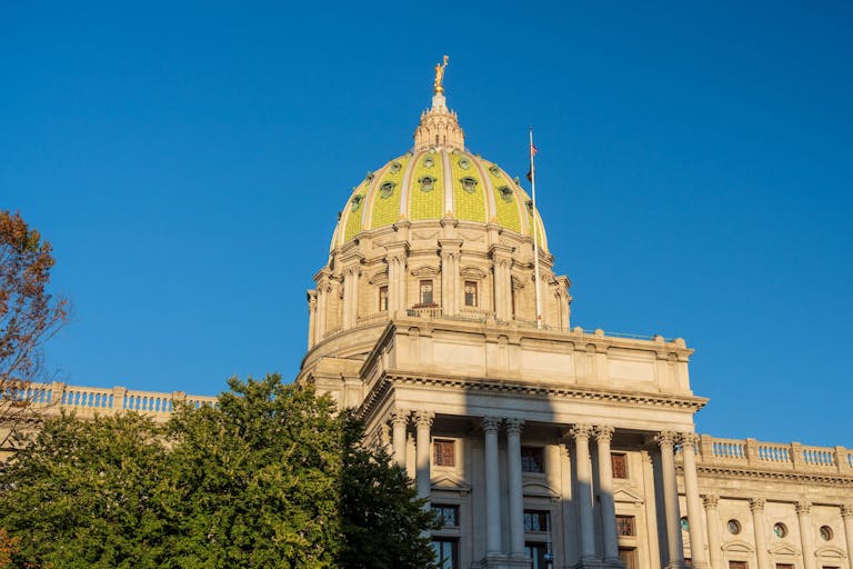 Setting sun shines on the ornate dome of Pennyslvania State Capitol