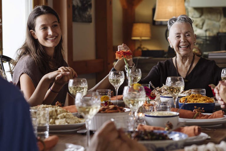 Happy family holding hands during Thanksgiving at home