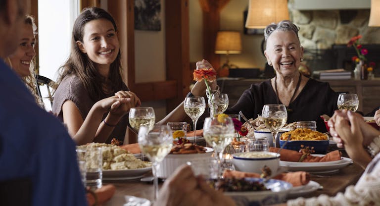 Happy family holding hands during Thanksgiving at home