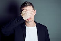Young male cover his eyes