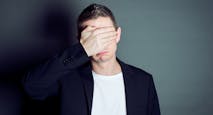Young male cover his eyes