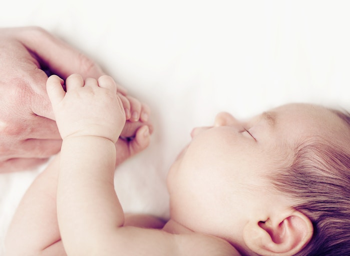 white-baby-finger-holding-hand
