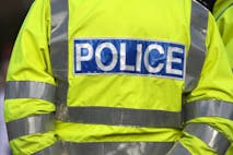 Back view of a police officer in reflexive jacket