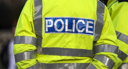 Back view of a police officer in reflexive jacket