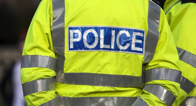 Back view of a police officer in reflexive jacket