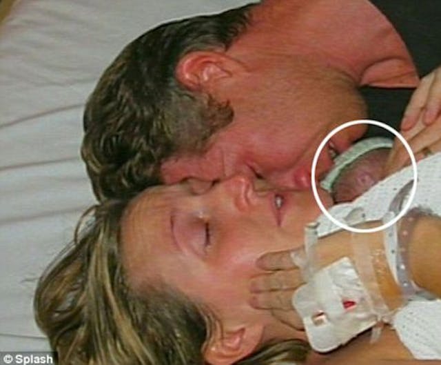 Jamie’s parents Kate and David Ogg embrace their newborn, pronounced dead by his physician shortly before. Jamie’s parents Kate and David Ogg embrace their newborn, pronounced dead by his physician shortly before.