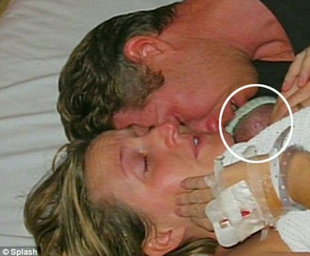 Jamie’s parents Kate and David Ogg embrace their newborn, pronounced dead by his physician shortly before.