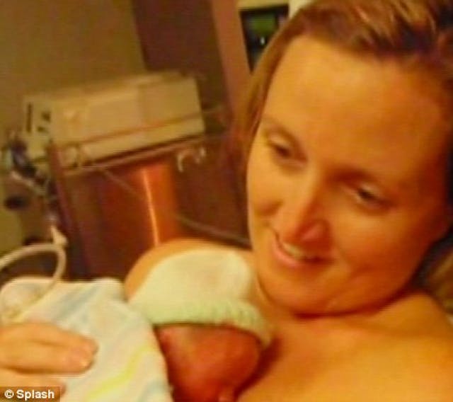 Kate Ogg, Jamie’s mother, smiles as she cradles her live baby after bringing him back to life with skin-to-skin contact and plenty of maternal affection.
