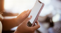 teenage girl using smart phone in her home
