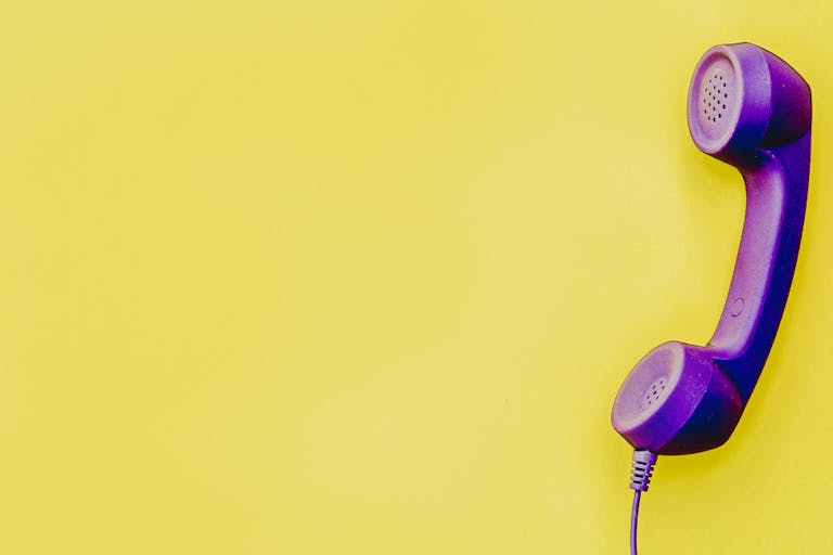 telephone handset in yellow background