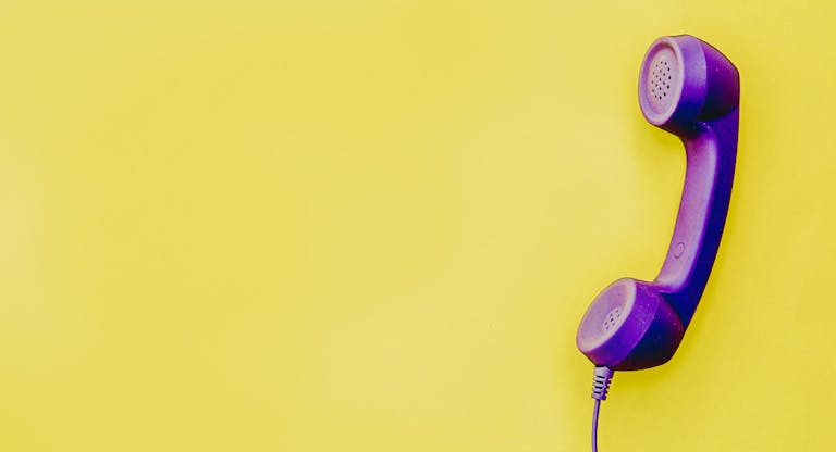 telephone handset in  yellow background