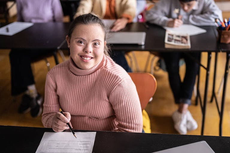 Portrait of a young woman with special needs in the classroom