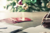 Photo: Dan Brownsword/Getty Images Person writing christmas cards