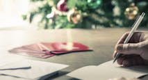 Person writing christmas cards